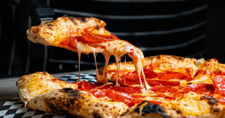 "Golden-brown Chicken and Cheese Jalousie pastry with flaky layers, tender chicken, and melted cheese filling, served on a rustic wooden cutting board."